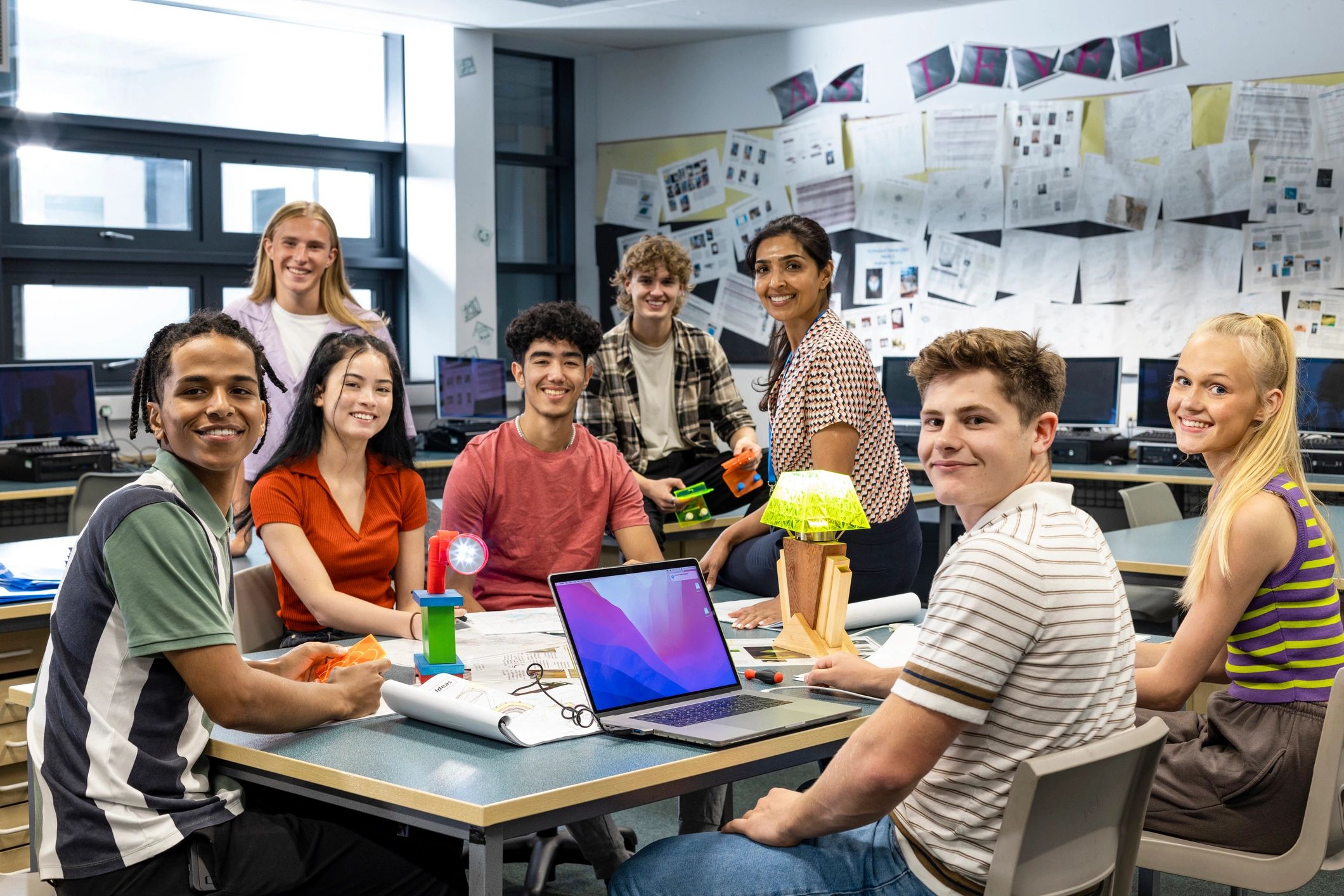 Instructor and students gathered in a technology class