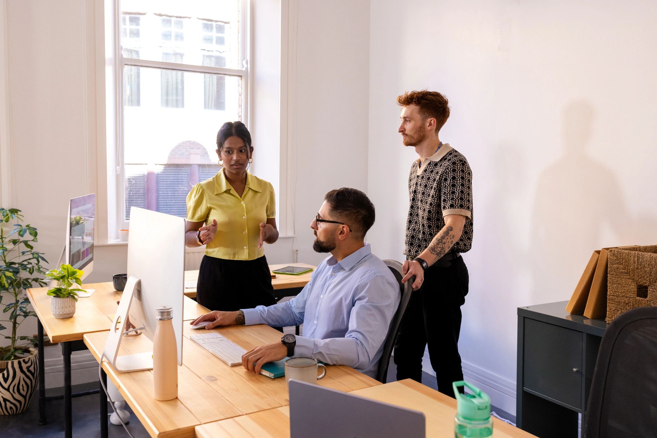Creative team discussing digital strategy in an office