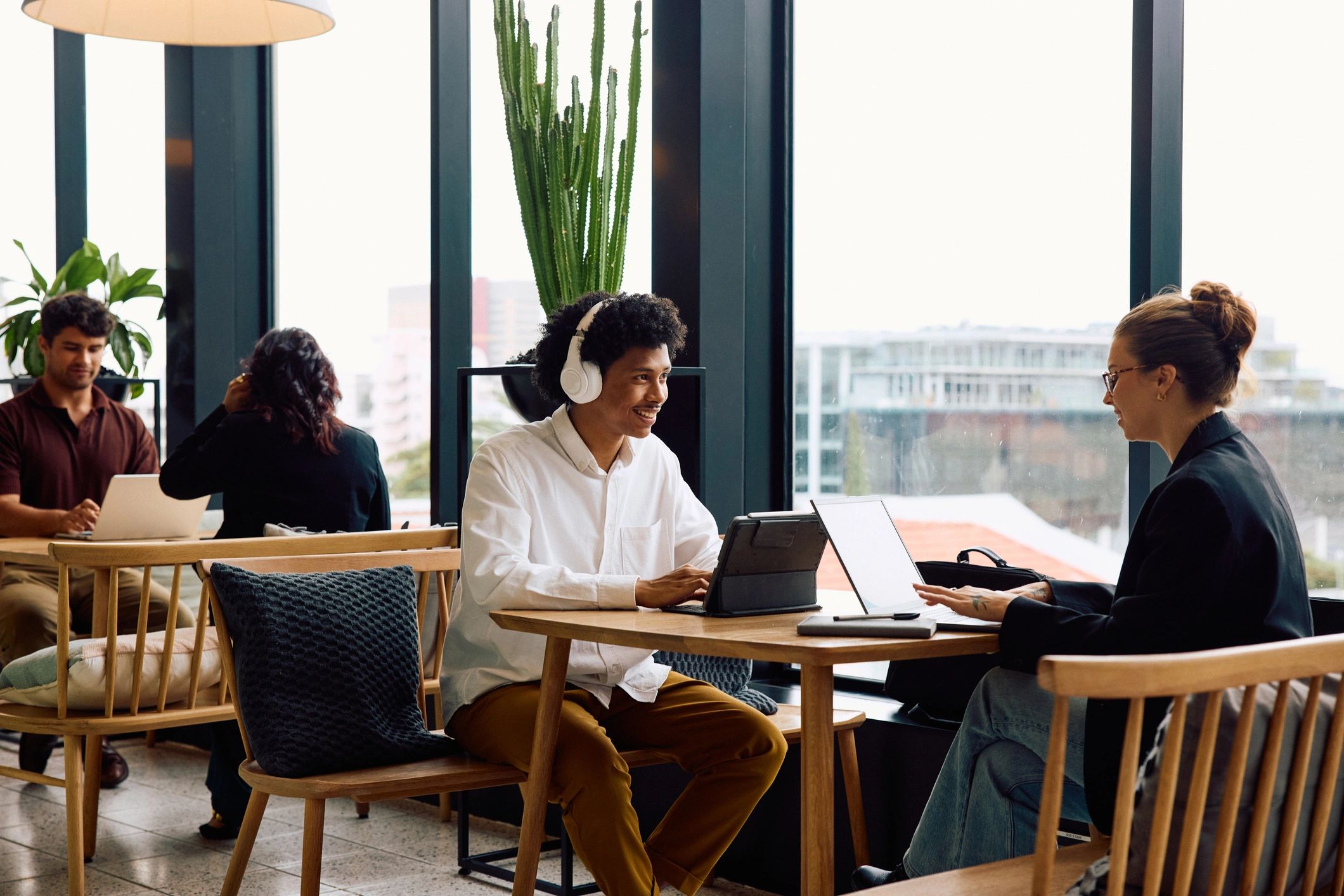 Group collaborating with laptops in a modern coworking space